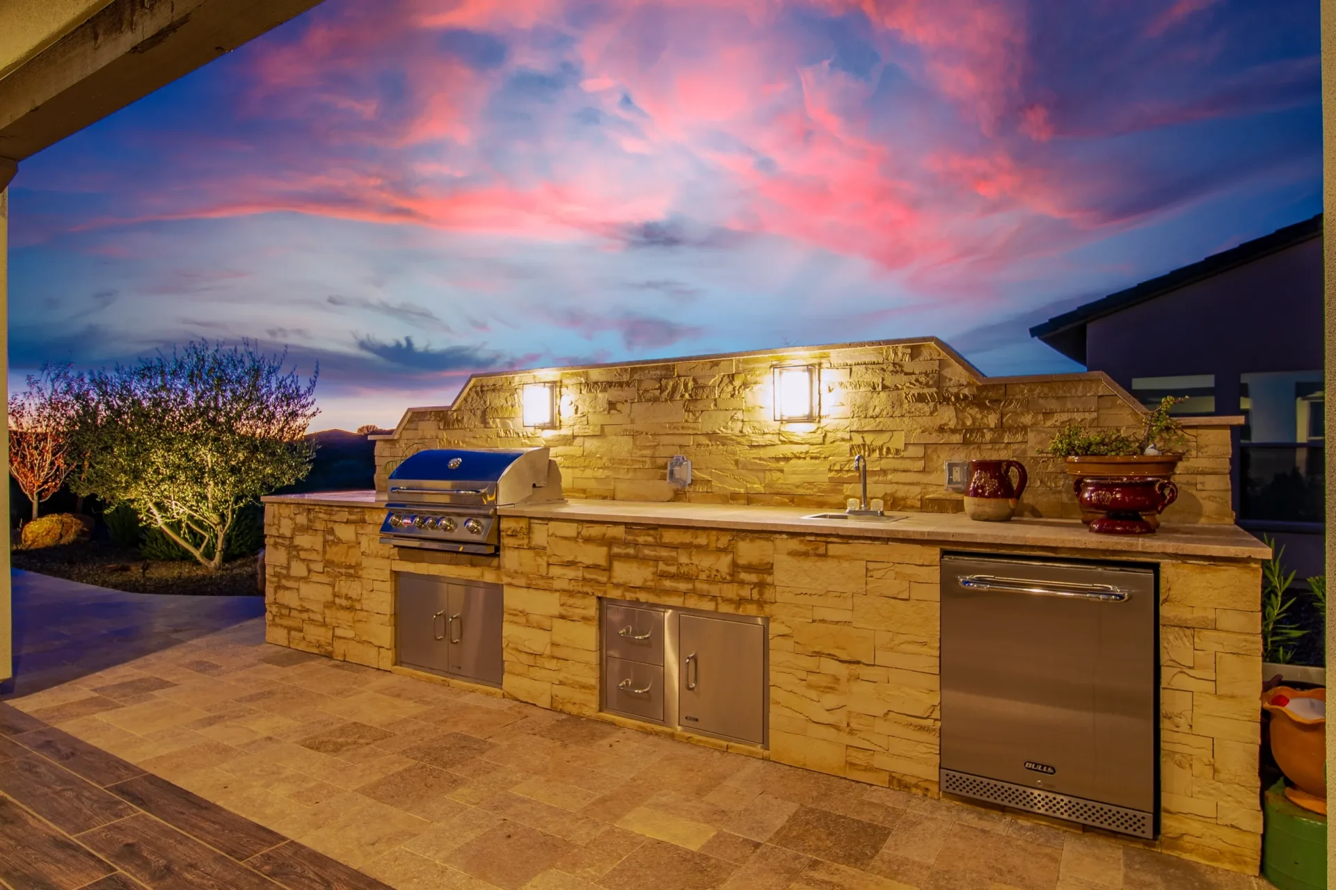 A outside kitchen with a rock theme